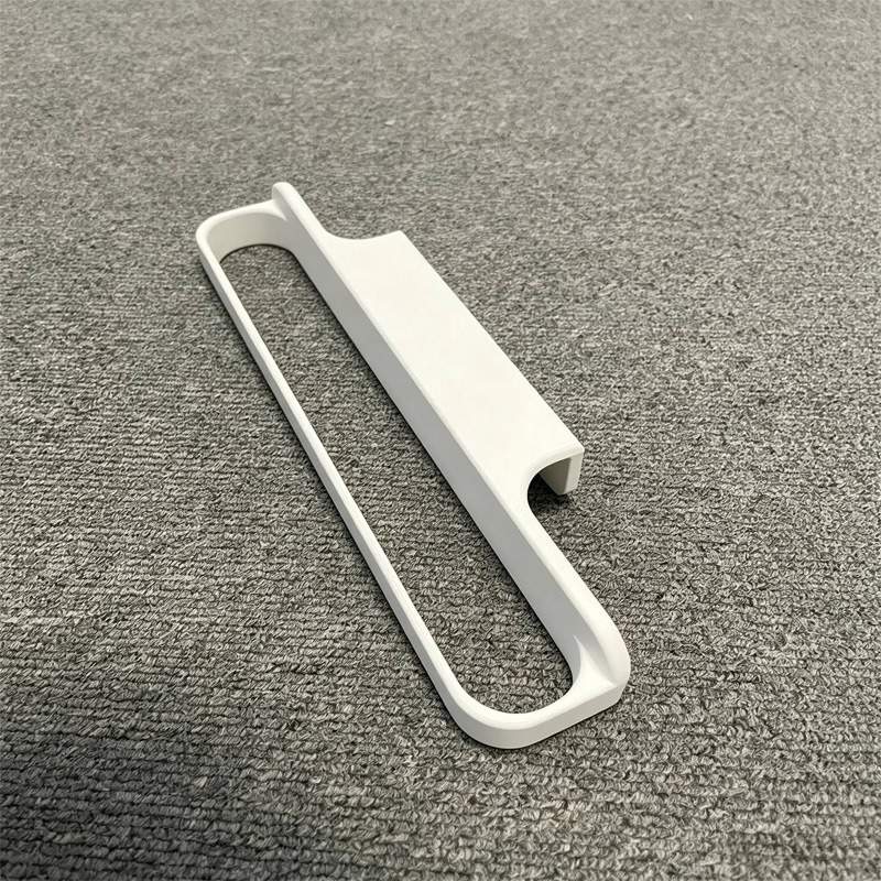 Loose white towel rack showing the rail and hook-like body profile on grey fabric.
