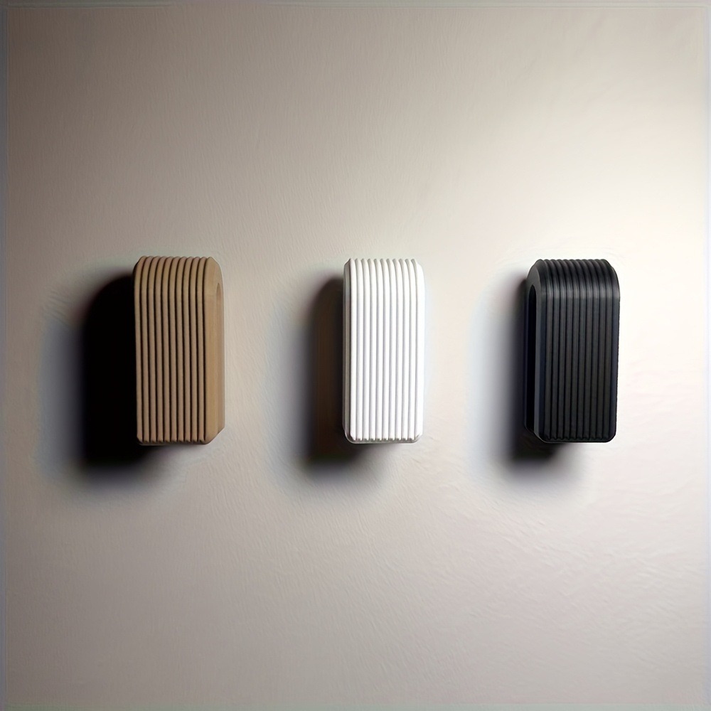 Three ribbed holder colour references shown on a wall without towels.